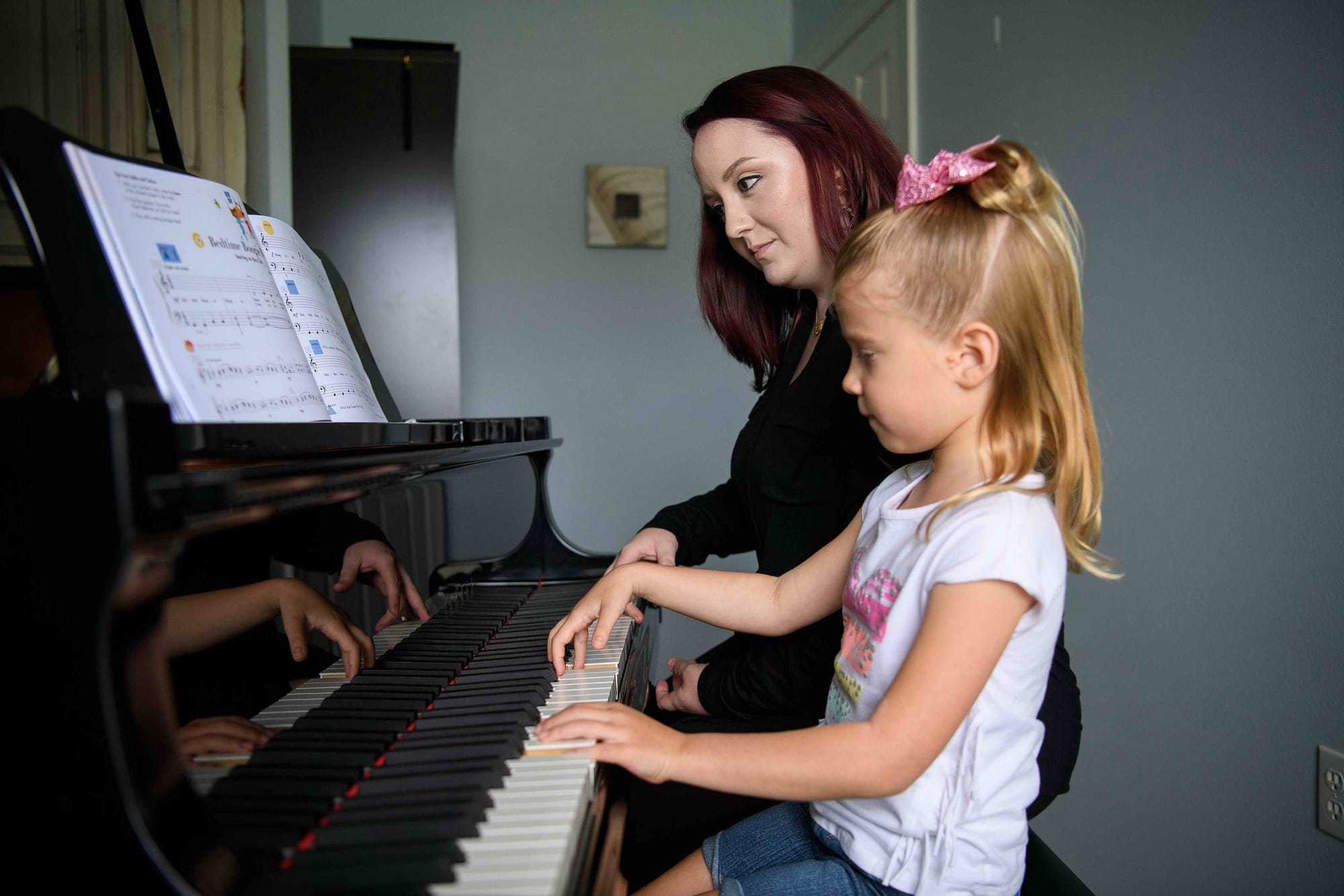 Teacher and young student piano lesson