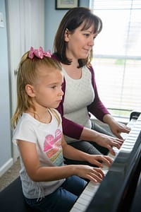 Piano teacher with student