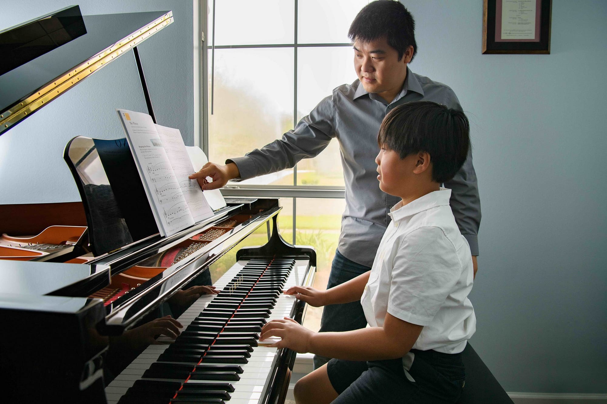 student and teacher piano lesson