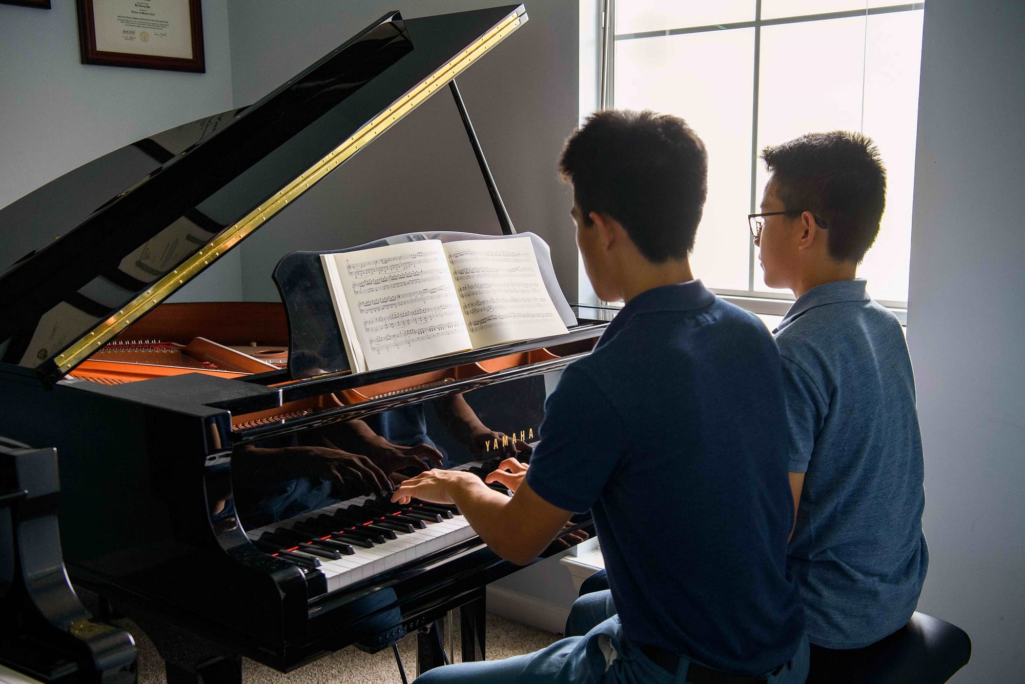 High school piano duet students