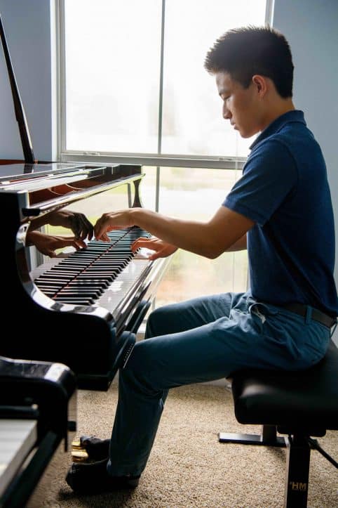 High school student playing piano
